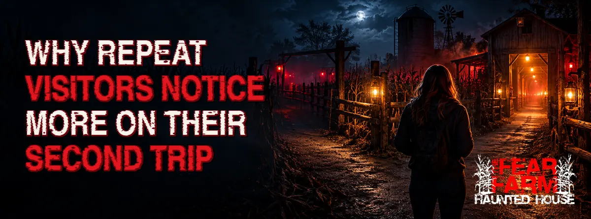 Visitor facing a lantern-lit path at a haunted farm attraction
